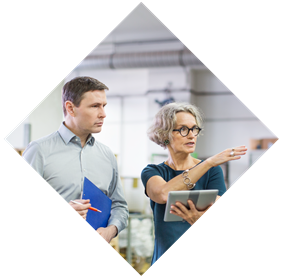 A Man Holding Paperwork and a Woman Holding a Tablet Whilst Talking Diamond Graphic